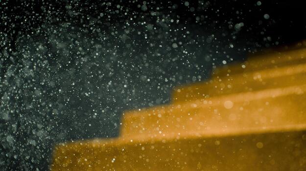 Water droplets spark joy near golden steps in the evening photo