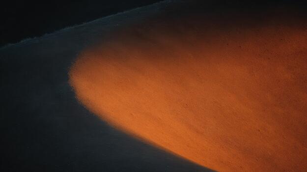 Light casts warm glow on textured surface at sunset photo