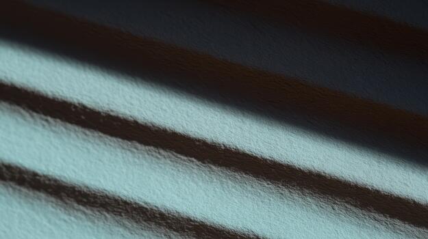 Shadows and light create patterns on textured surface photo