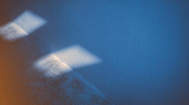 Light patterns create mood on textured wall surface photo