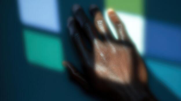 Hand reaching toward colorful light patterns photo