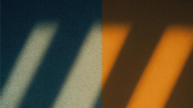 Shadows play across a textured surface in warm hues photo