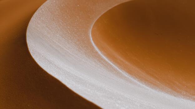 Curved lines of smooth sand create a serene desert landscape photo