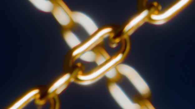 Close-up of golden chains interlinking in clear focus photo
