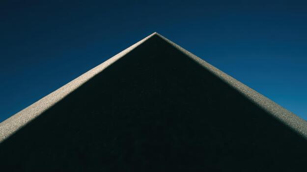 Pyramid structure under a clear blue sky photo