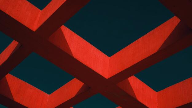 Red geometric structure under clear blue sky photo