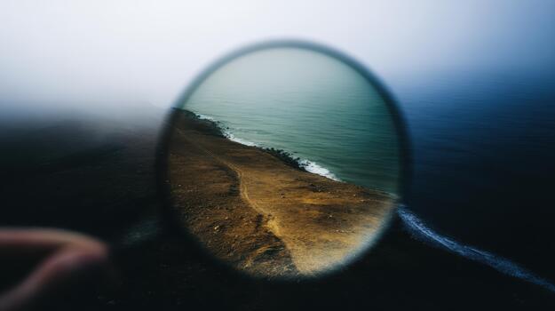 explorador el línea costera mediante un aumentador vaso foto
