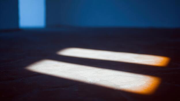 Sunlight casting shadows in a quiet room during day photo