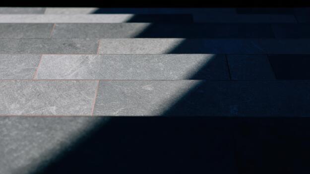 Shadows and light create patterns on stone flooring photo