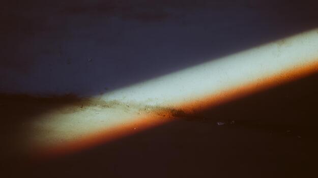 Light and shadow create a colorful pattern on the wall photo