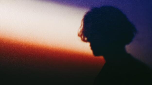 Silhouette at sunset with colorful gradient background photo