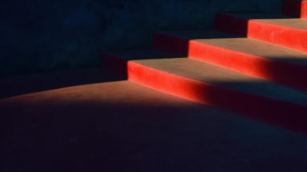 Bright red stairs casting shadows in evening light photo
