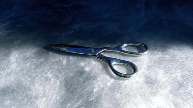 Scissors resting on a soft surface in bright light photo