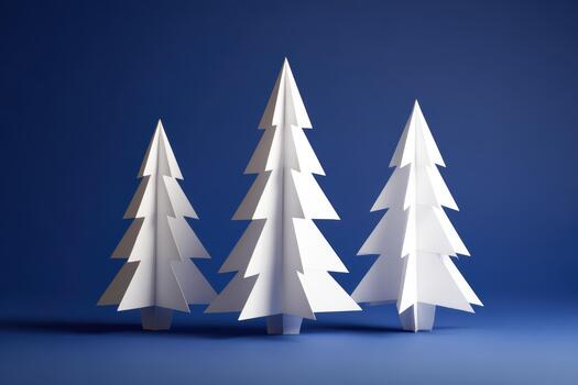 White paper trees arranged on a blue background photo