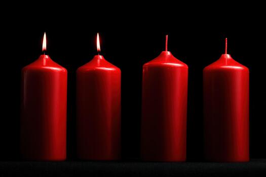 Candlelit display of red candles in the dark photo