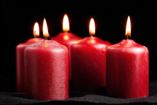 Red candles glowing softly in a dark setting photo