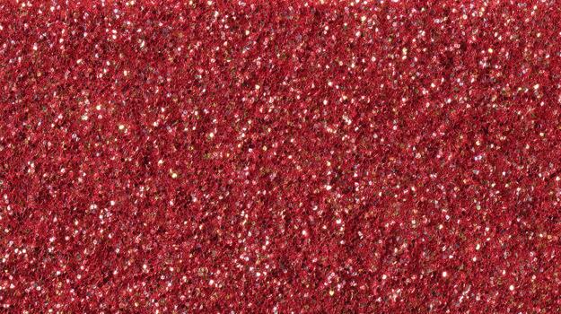 Shimmering red glitter shines brightly in sunlight photo