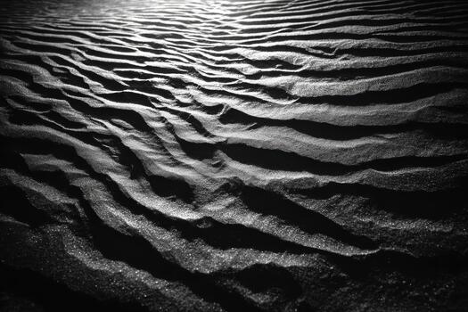 Patterns of sand on a beach in black and white photo