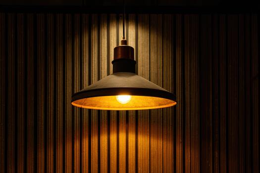 Warm light from modern pendant lamp in cozy space photo