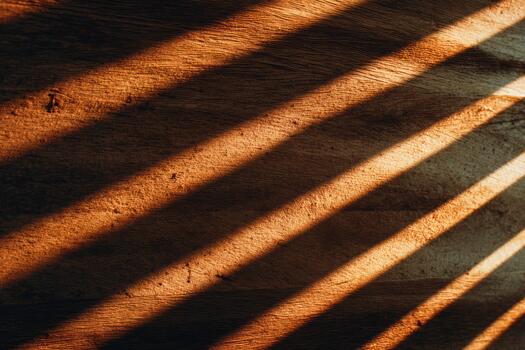 Shadows creating patterns on a wooden surface photo