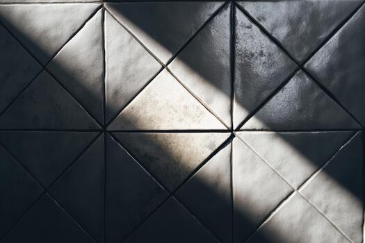 Textured wall with triangular patterns and light photo