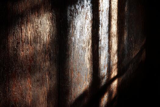 Warm light casting shadows on a rustic wooden wall photo