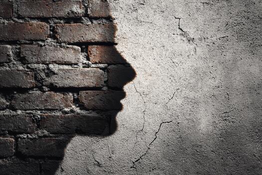 Silhouette of a face against a textured wall photo