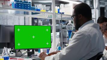 Scientist using isolated screen tablet app in laboratory, driving treatment discovery. Expert using bioinformatics software on mockup touchscreen device in sterile lab, camera B video