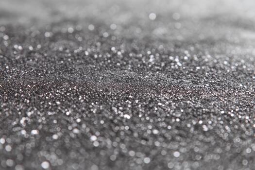 Shimmering black surface covered in fine particles photo