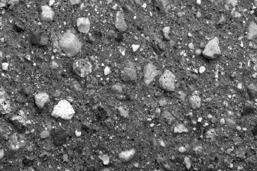 Textured surface of gravel with various stones and particles photo