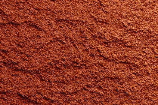 Natural reddish texture on a rough surface in warm light photo
