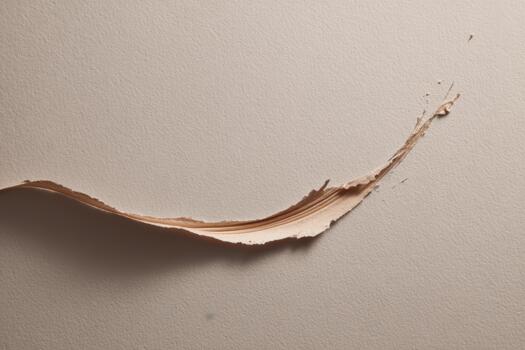 Tear in textured paper revealing smooth surface underneath photo