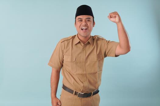 Smiling government worker with khaki uniform He is raising hands in the air for a picture. He is posing for a picture PNS, ASN civil servant concept, photo