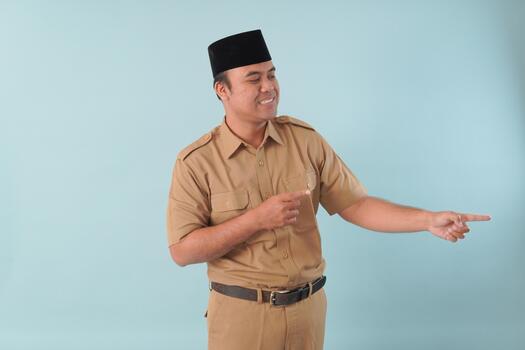 government worker with khaki uniform giving gesturing pointing at the copy space a picture PNS, ASN, civil servant concept photo