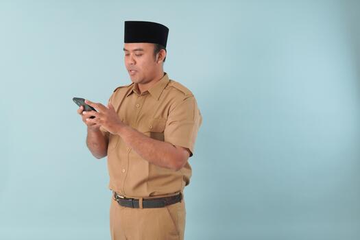 Smiling government worker with khaki uniform He, is doing call while pointing to his smartphone PNS, ASN civil servant concept. photo