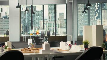 Real estate developers and architects in a modern office reviewing blueprints and 3D models. Diverse development team discusses urban planning and property investment strategies. Camera B. video