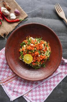Trancam is a traditional salad from Java, Indonesia made from fresh vegetables such as cucumber, basil, long beans, and white cabbage, which are cut into pieces and photo