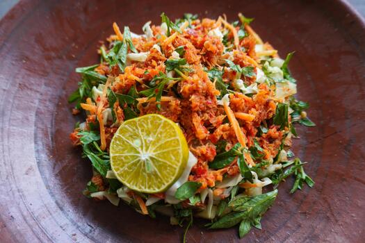 Trancam is a traditional salad from Java, Indonesia made from fresh vegetables such as cucumber, basil, long beans, and white cabbage, which are cut into pieces and mixed with. photo