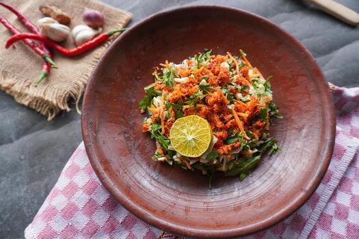 Trancam is a traditional salad from Java, Indonesia made from fresh vegetables such as cucumber, basil, which are cut into pieces and mixed with grated coconut with spices. photo