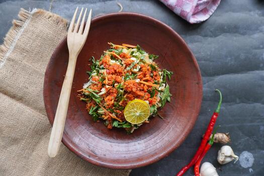 Trancam is a traditional salad from Java, Indonesia made from fresh vegetables such as cucumber, basil,which are cut into pieces and mixed with grated coconut with spices. photo