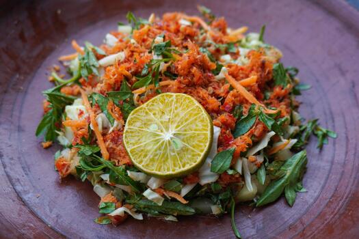 Trancam is a traditional salad from Java, Indonesia made from fresh vegetables such as cucumber, basil, long beans, and white cabbage, mixed with grated coconut with spices. photo