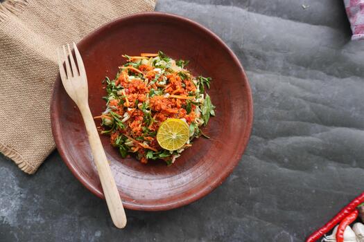 Trancam is a traditional salad from Java, Indonesia made from freshvegetables such as cucumber, basil, long beans, and white cabbage, which are cut into pieces and mixed with grated coconut photo
