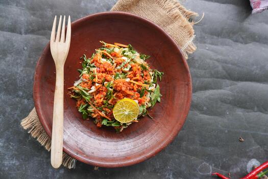 Trancam is a traditional salad from Java, Indonesia made from fresh vegetables such as cucumber, basil, long beans which are cut into pieces and mixed with grated coconut with spices. photo