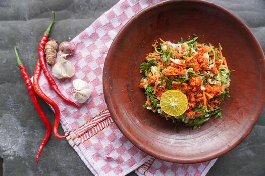 Trancam is a traditional salad from Java, Indonesia made from fresh vegetables such as cucumber, basil, long beans, which are cut into pieces and mixed with grated coconut with spices. photo