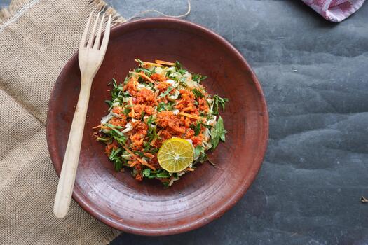 Trancam is a traditional salad from Java, Indonesia made from fresh vegetables such as cucumber, long beans, and white cabbage, which are cut into pieces and mixed with grated coconut with spices photo