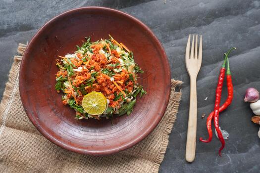 Trancam is a traditional salad from Java, Indonesia made from fresh vegetables such as cucumber, basil, long beans, and white cabbage, which are cut into pieces and mixed photo