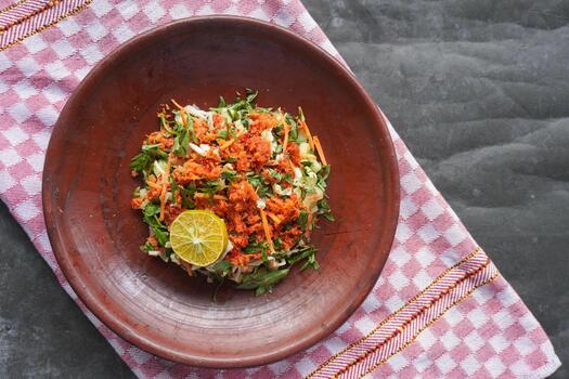 Trancam is a traditional salad from Java, Indonesia made from fresh vegetables such as cucumber, basil, and white cabbage, which are cut into pieces and mixed with grated coconut with spices. photo