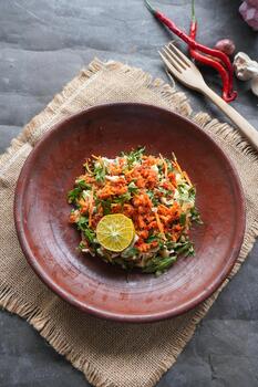 Trancam is a traditional salad from Java, Indonesia made from fresh vegetables such as cucumber, basil, long beans, and white cabbage, which are cut into pieces photo