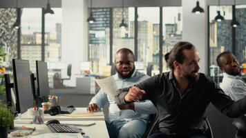 dipendenti rivedere grafici e diagrammi durante un' progetto riunione. aziendale manager conduce discussioni su pianificazione, documentazione e rapporto scrittura per migliorare attività commerciale informazioni telecamera b. video