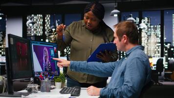 Diverse photo editing team generating AI content and retouching pictures, working on their creative portfolio with text to image program and futuristic software. Advanced editors. Camera B. video